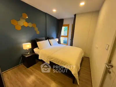 Cozy bedroom with modern decor and warm lighting, featuring a comfortable bed and stylish wall art.
