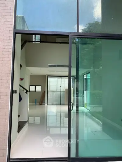 Modern open-concept living space with large glass doors and natural light