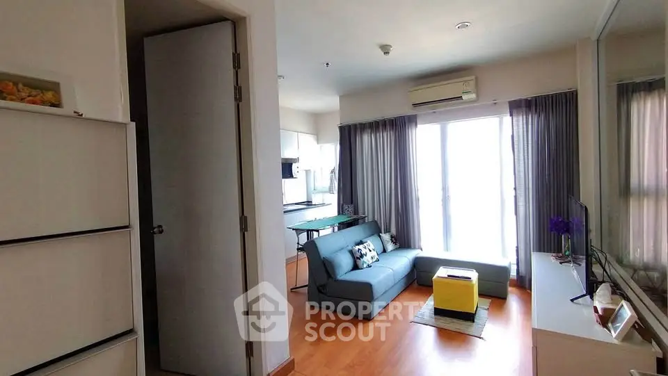 Modern living room with sleek furniture and natural light in a stylish apartment.