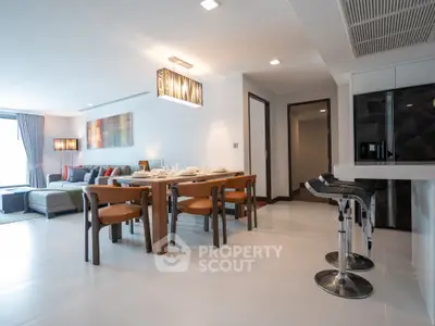 Spacious modern living and dining area with stylish furniture and open layout.