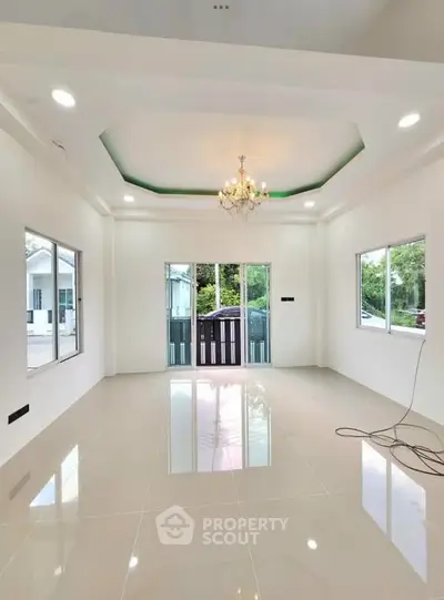 Spacious and elegant living room with chandelier and large windows