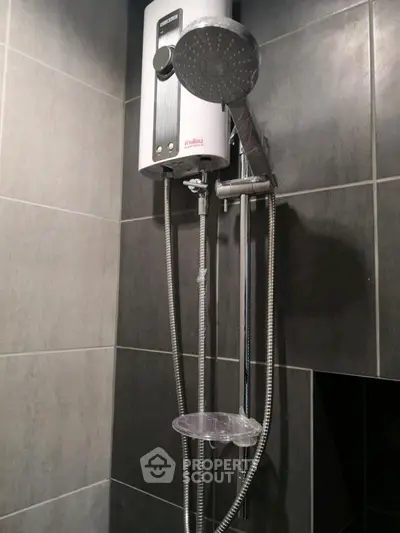 Modern bathroom shower with sleek black tiles and water heater