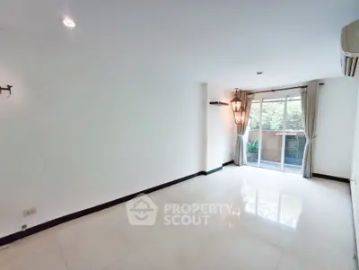 Spacious living room with large windows and garden view