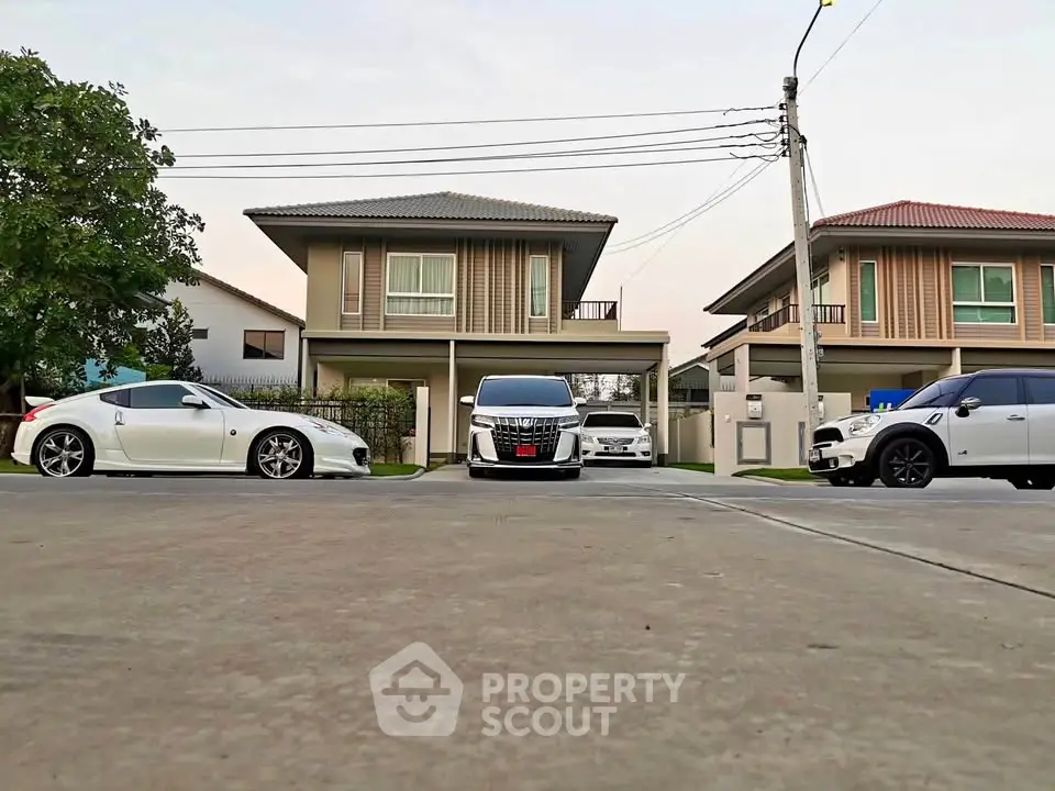 Modern suburban homes with stylish cars parked in the driveway, showcasing contemporary architecture and design.