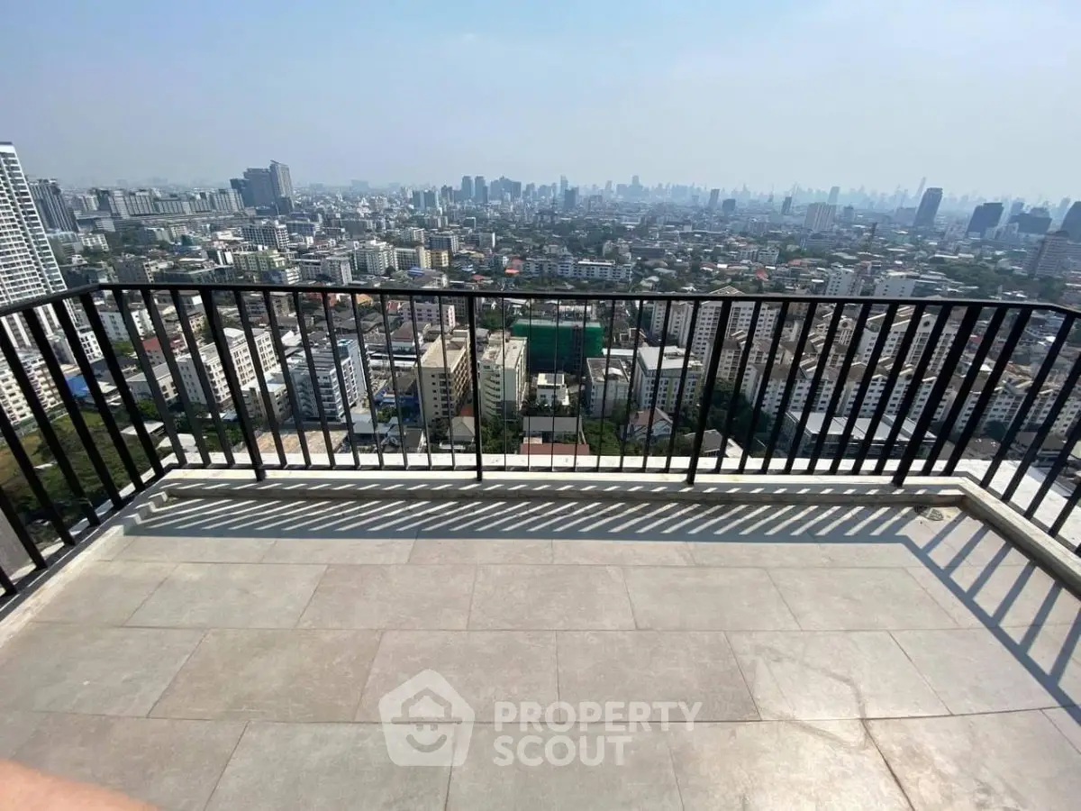 Stunning cityscape view from a spacious balcony in a high-rise building, perfect for urban living.