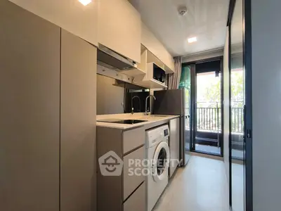 Modern kitchen with washing machine and balcony view