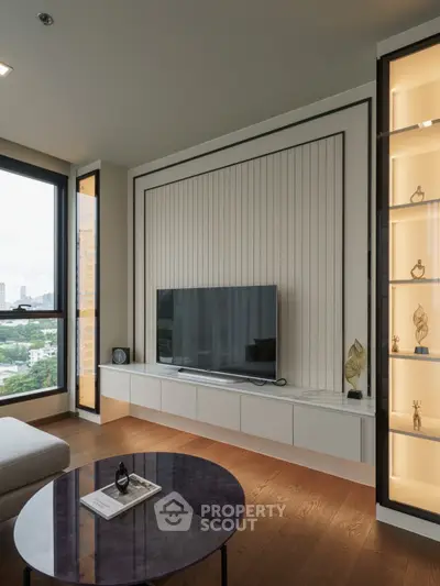 Modern living room with sleek TV setup and elegant decor, featuring large windows and stylish shelving.