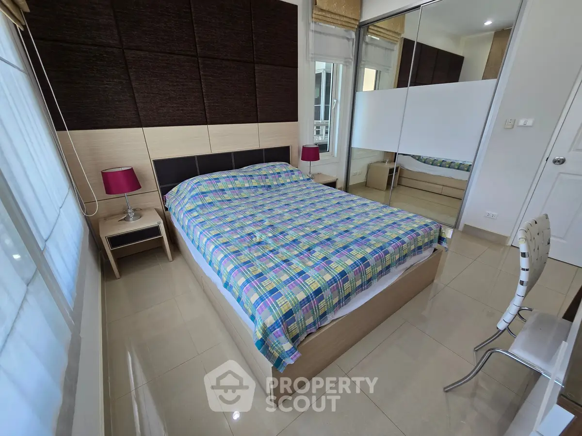 Modern bedroom with stylish decor and ample natural light