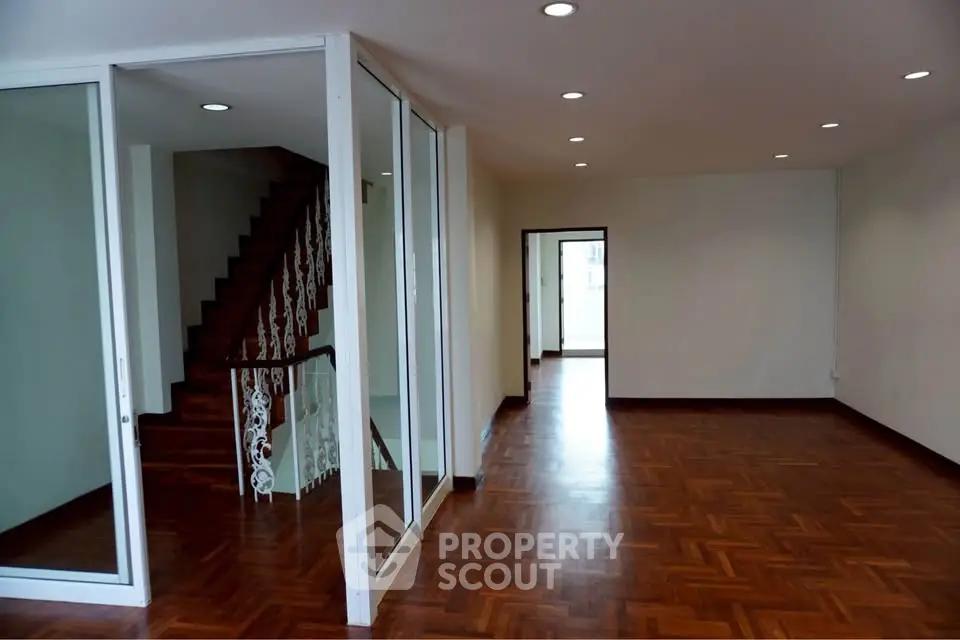 Spacious interior with wooden flooring and elegant staircase, perfect for modern living.