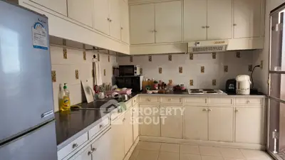 Charming kitchen with closed layout and ample storage, featuring modern appliances and a cozy atmosphere.