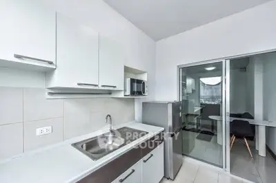 Modern kitchen with sleek cabinets and stainless steel appliances