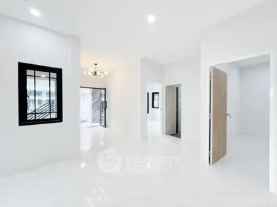 Spacious modern interior with white marble flooring and elegant lighting.