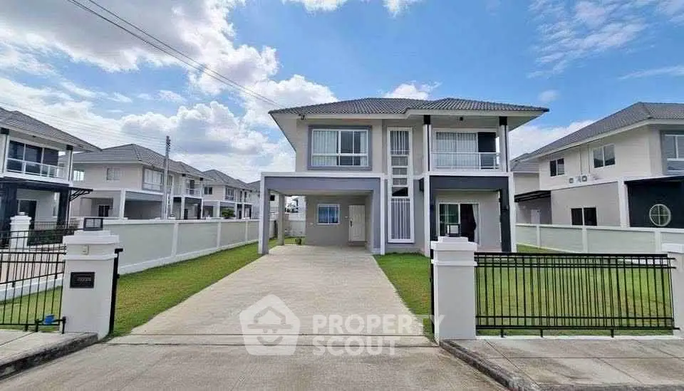 Modern two-story house with spacious driveway and manicured lawn in a suburban neighborhood.