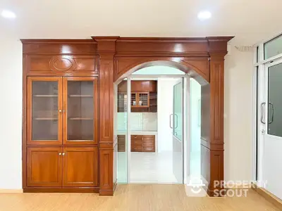 Elegant wooden archway with built-in cabinets in a modern interior space