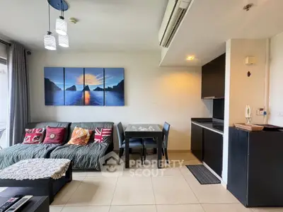 Modern living room with stylish decor and open kitchen layout in a cozy apartment.