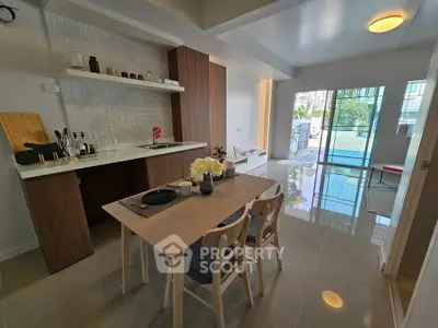 Modern open-plan kitchen and dining area with sleek design and natural light.