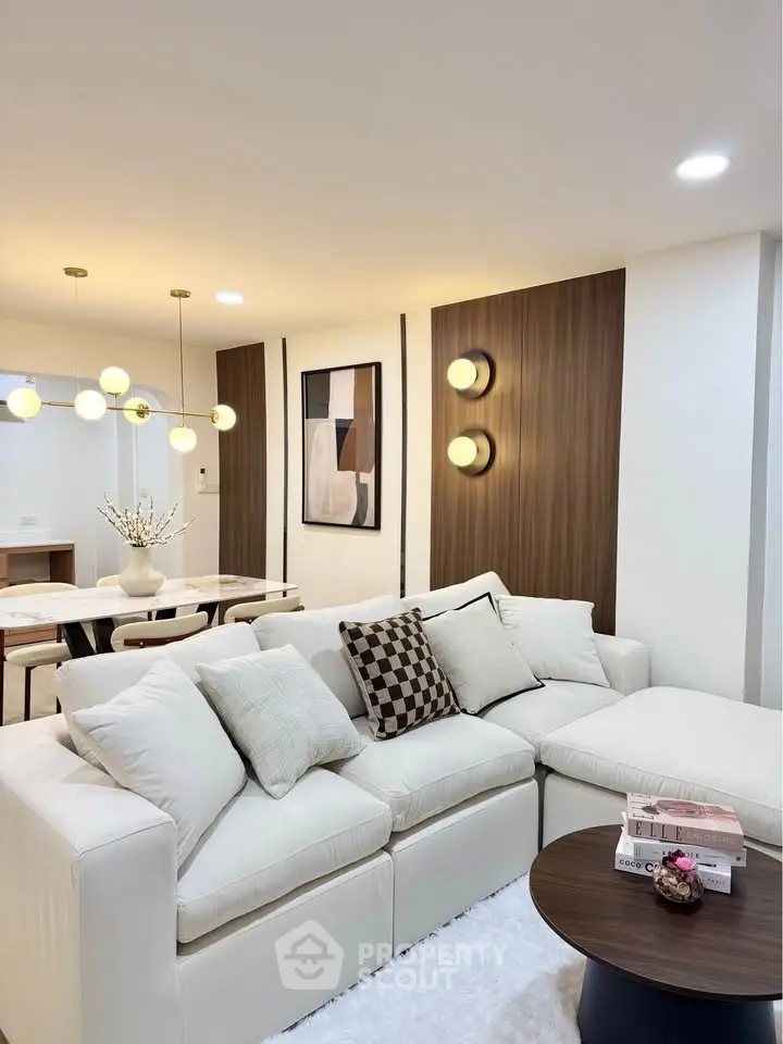 Elegant living room with modern decor and cozy seating area, perfect for relaxation and entertaining.