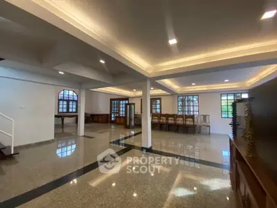 Spacious open-plan living area with elegant lighting and polished flooring