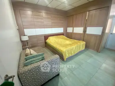 Spacious bedroom with modern decor and ample storage in a stylish apartment.