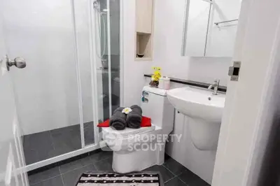 Modern bathroom with sleek fixtures and glass shower enclosure