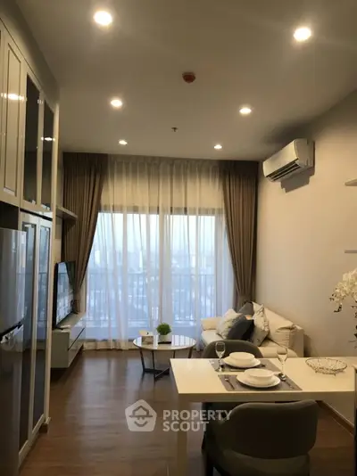 Modern living room with elegant decor and balcony view in a stylish apartment.