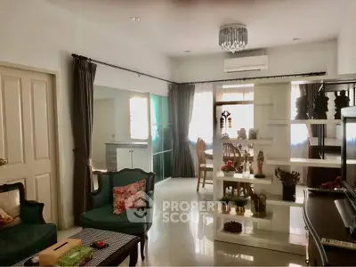 Spacious living room with elegant decor and natural light, featuring a stylish partition and comfortable seating.