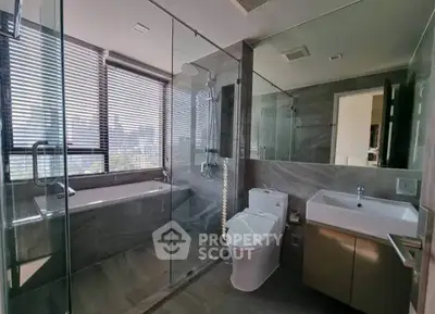 Luxurious modern bathroom with glass shower and city view