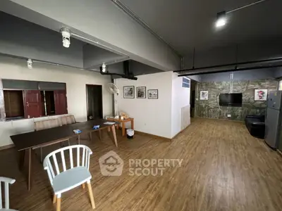 Spacious open-plan living area with modern decor and wooden flooring