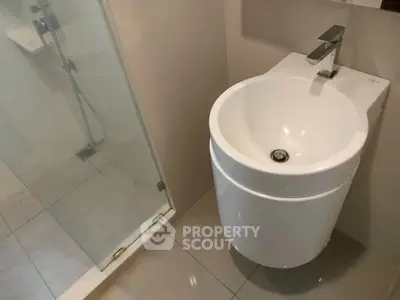 Modern bathroom with sleek sink and glass shower enclosure
