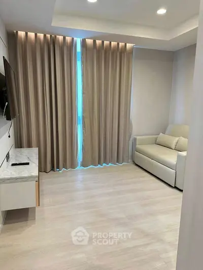 Modern living room with sleek design, cozy sofa, and wall-mounted TV.