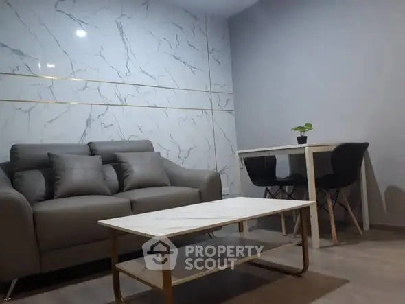 Modern living room with marble accent wall and stylish furniture