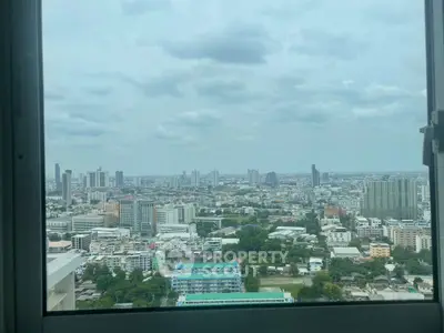 Stunning cityscape view from high-rise window showcasing urban skyline.