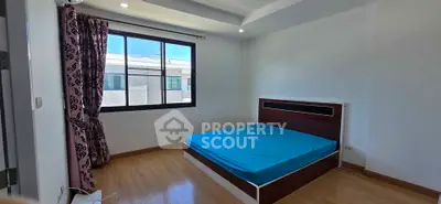 Spacious bedroom with large window and modern bed frame, perfect for natural light lovers.