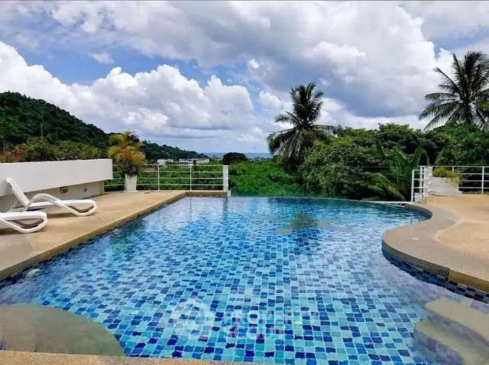 Stunning infinity pool with ocean view and lush greenery, perfect for luxury relaxation.