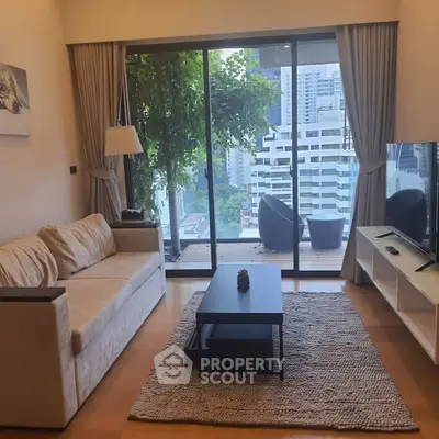 Modern living room with city view, cozy sofa, and large TV.