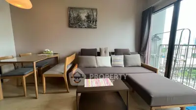 Modern living room with stylish furniture and balcony view in urban apartment