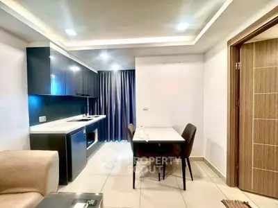 Modern kitchen and dining area with sleek cabinetry and cozy seating in a stylish apartment.