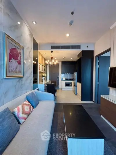 Modern living room with elegant decor and open kitchen layout in a stylish apartment.