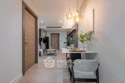 Modern dining area with elegant lighting and cozy seating in a stylish apartment.
