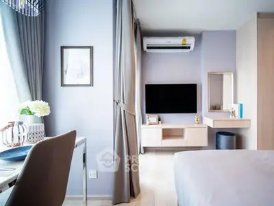 Modern bedroom with stylish decor and wall-mounted TV in a cozy apartment.