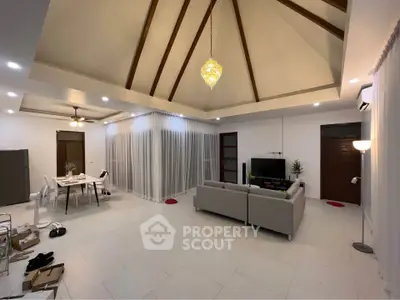 Spacious living room with high ceiling and modern decor