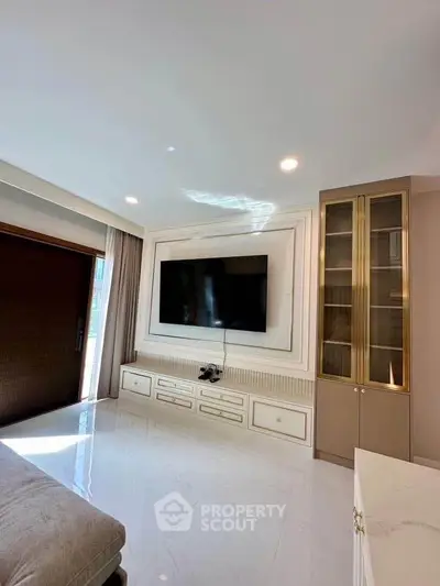Luxurious living room with modern TV setup and elegant cabinetry