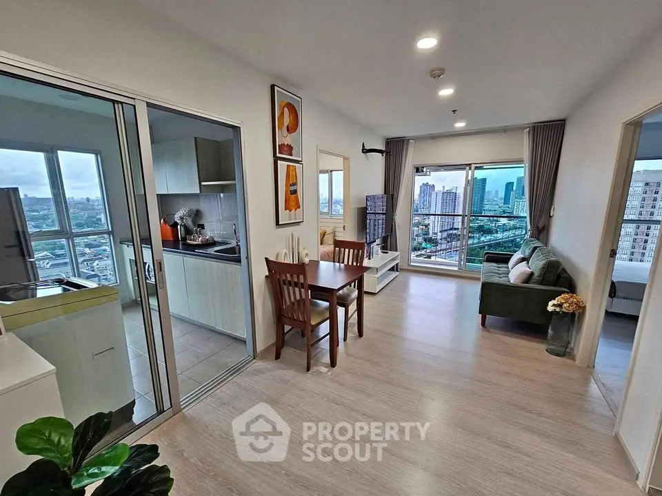 Spacious modern living room with city view, open layout, and stylish decor in high-rise apartment.