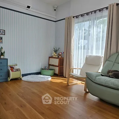 Charming living room with wooden flooring and cozy seating area