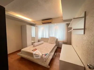 Spacious bedroom with modern design and ample natural light