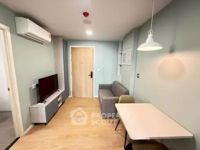 Modern living room with stylish decor and compact furniture in a cozy apartment.