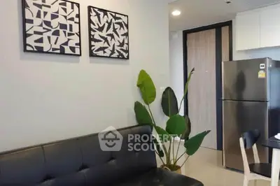 Modern living room with stylish decor and sleek kitchen appliances