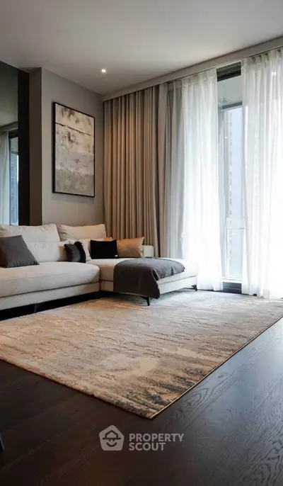 Elegant living room with modern decor and large window, featuring a cozy sectional sofa and stylish rug.