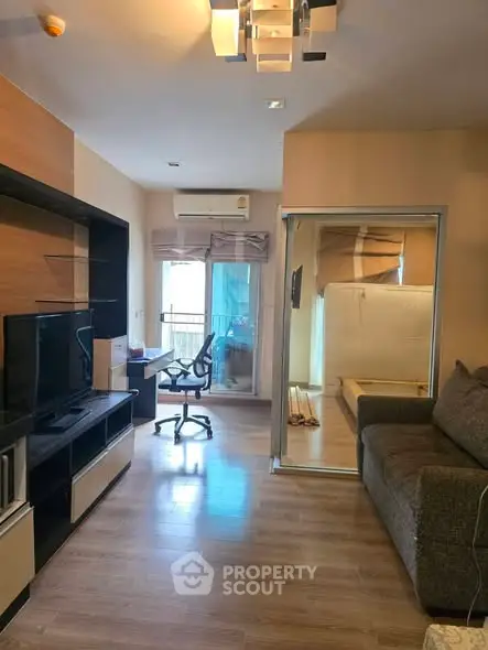 Modern living room with sleek furniture and balcony access in a stylish apartment.