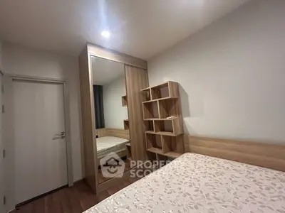 Modern bedroom with wooden furniture and large mirror wardrobe